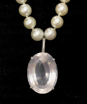 45 carat kunzite set in a custom sterling silver pendant on a strand of 8-9mm freshwater pearls.