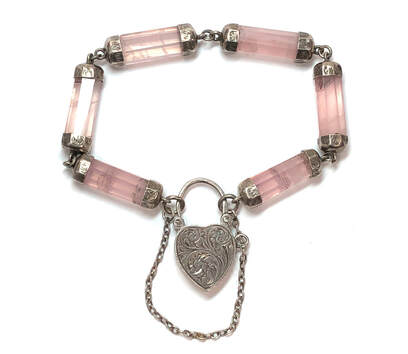 English made, Victorian era antique love bracelet featuring faceted rose quartz columnar links with hand chased sterling silver end caps, fastened by a hand chased sterling silver heart padlock clasp