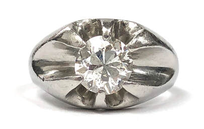 Vintage solitaire diamond ring in a platinum belcher setting