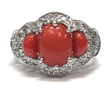Precious red coral was custom cut to fit this vintage platinum & diamond ring setting