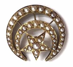 Late Victorian Era antique Masonic Shriners pin featuring graduated seed pearls in a crescent and star motif.