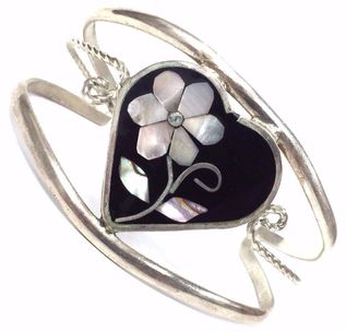 Mother of pearl, diamond and jet inlay in a sterling silver cuff bracelet.
