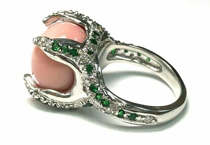 Tsavorites and diamonds accent this 18K white gold conch pearl ring