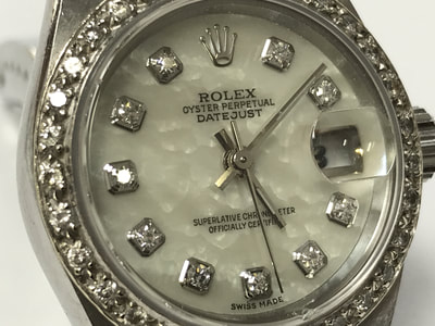 Lady Rolex stainless steel Datejust with mother of pearl and diamond dial, and customized diamond bezel.