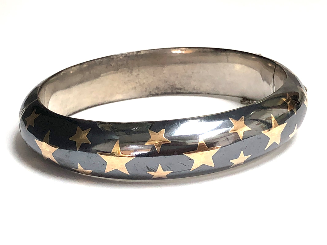 Beautiful, Edwardian era antique bangle bracelet featuring a niello silver and 14K gold star inlay.