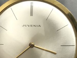 Flat, painted metal dial on a vintage Juvenia dress pocket watch with date complication.