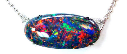 Extremely fine quality Australian black opal and trillion cut diamond necklace in platinum