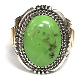 This vintage Navajo ring, by Will Denetdale, features a yellow-green gaspeite hammer set in a sterling silver & 14K gold setting