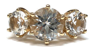 10K Gold three-stone ring set with round brilliant cut colorless topaz