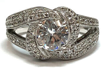 Designer engagement ring, by Vanna K, featuring a cubic zirconia center with pavé-set CZ accents, in sterling silver