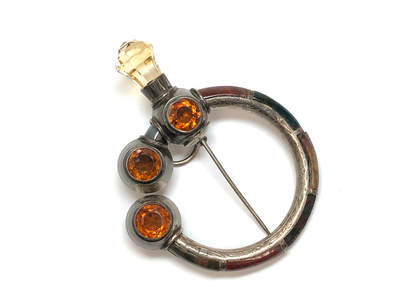 Antique, Victorian era penannular brooch (Celtic brooch) set with vivid orange citrines, pale yellow citrine, and jasper set in hand chased sterling silver.