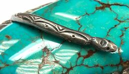 A very creative, hand-wrought, sterling silver snake is used as a prong to secure this massive piece of turquoise with red matrix, in a Navajo belt buckle