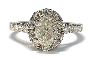 An oval brilliant cut diamond engagement ring in a halo setting