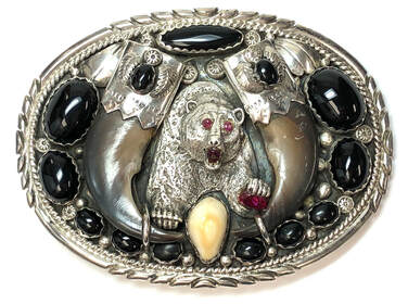 Bears represent strength, courage and leadership in Native American culture.  A bear is the centerpiece of this magnificent Navajo belt buckle by Dennis Kalisteo
