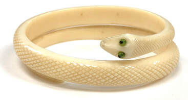 Antique, Victorian era, coiled snake bangle bracelet composed of hand-carved ivory.  Set with acrylic eyes