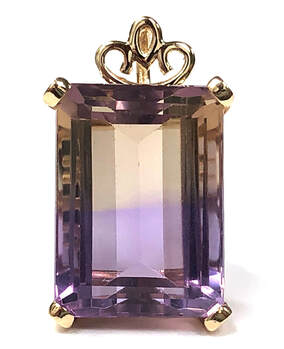 Photo of an emerald cut, bicolor quartz known as ametrine, set in a custom 14K gold pendant.  (Half amethyst, half citrine)