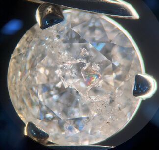 Rainbow flash effect visible in a fracture-filled, clarity enhanced diamond