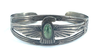 Fred Harvey Era thunderbird bracelet featuring green turquoise set in .900 coin silver