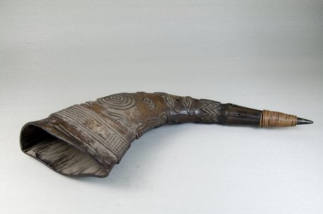 Large, carved buffalo horn on display at the Brooklyn Museum