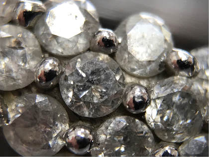 These imperfect, heavily included, I3 clarity diamonds have little brilliance due to the overwhelming amount of inclusions.