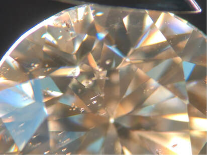 Needle-like, or nail-like inclusions in a lab-created moissanite