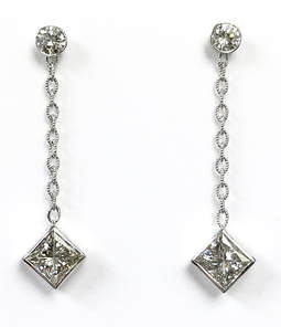 Custom made princess cut diamond drop earrings beneath round brilliant cut diamond studs.  All bezel set in white gold.