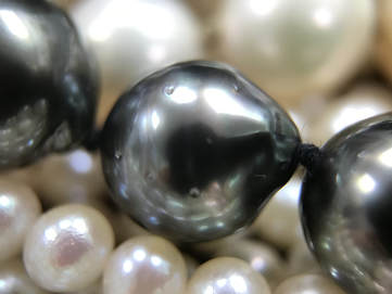 This Tahitian pearl is semi-baroque with moderate surface blemishing.