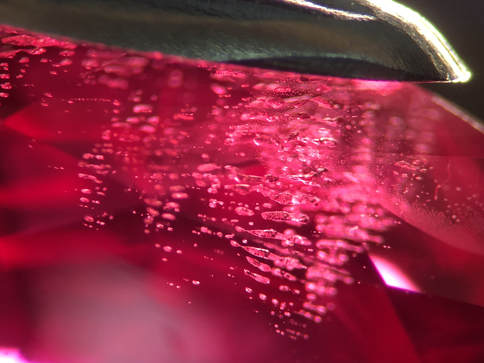 High relief, coarse flux inclusions in a synthetic ruby