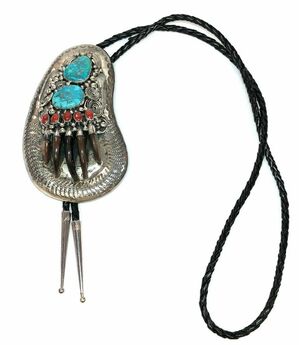 Vintage bolo tie handcrafted by Southwestern Navajo artisan, EJ David, featuring turquoise, red coral, and actual animal claws!