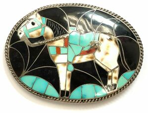 This vintage belt buckle by Southwestern Zuni artisans, Helen & Lincoln Zunie, features a turquoise, jet, tiger shell and spiny oyster inlay