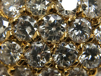 Close-up photograph of beautiful pavé work on this 18K gold and diamond earring