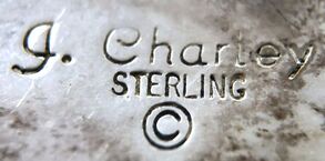 Jewelry trademark of Navajo silversmith, John Charley (J. Charley)