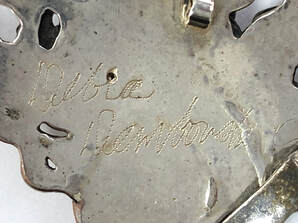 Jewelry signature of the late silversmith, Debra Dembowski