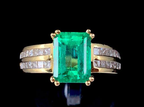 Colombian emerald and moissanite engagement ring