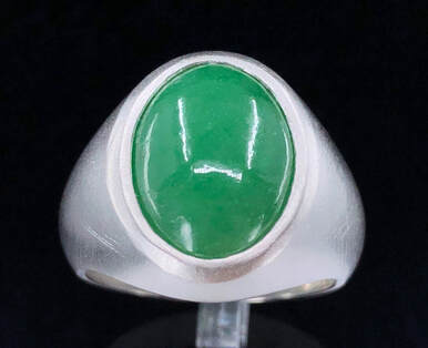 GIA 6.13 ct. Type A translucent green jadeite jade ring in brushed platinum.