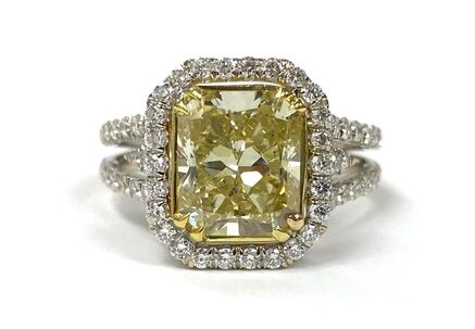 Fancy light yellow radiant cut diamond set in a pavé diamond setting.