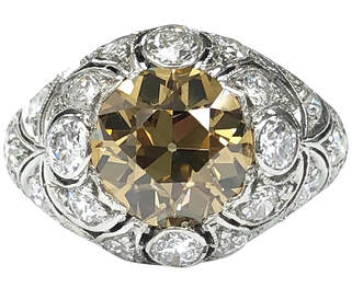 Magnificent Art Déco Era vintage platinum ring with a 2.25 ct old European cut fancy intense brownish yellow center, GIA certified