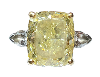 A well-worn 7.83 carat fancy intense yellow diamond ring, by Graff.